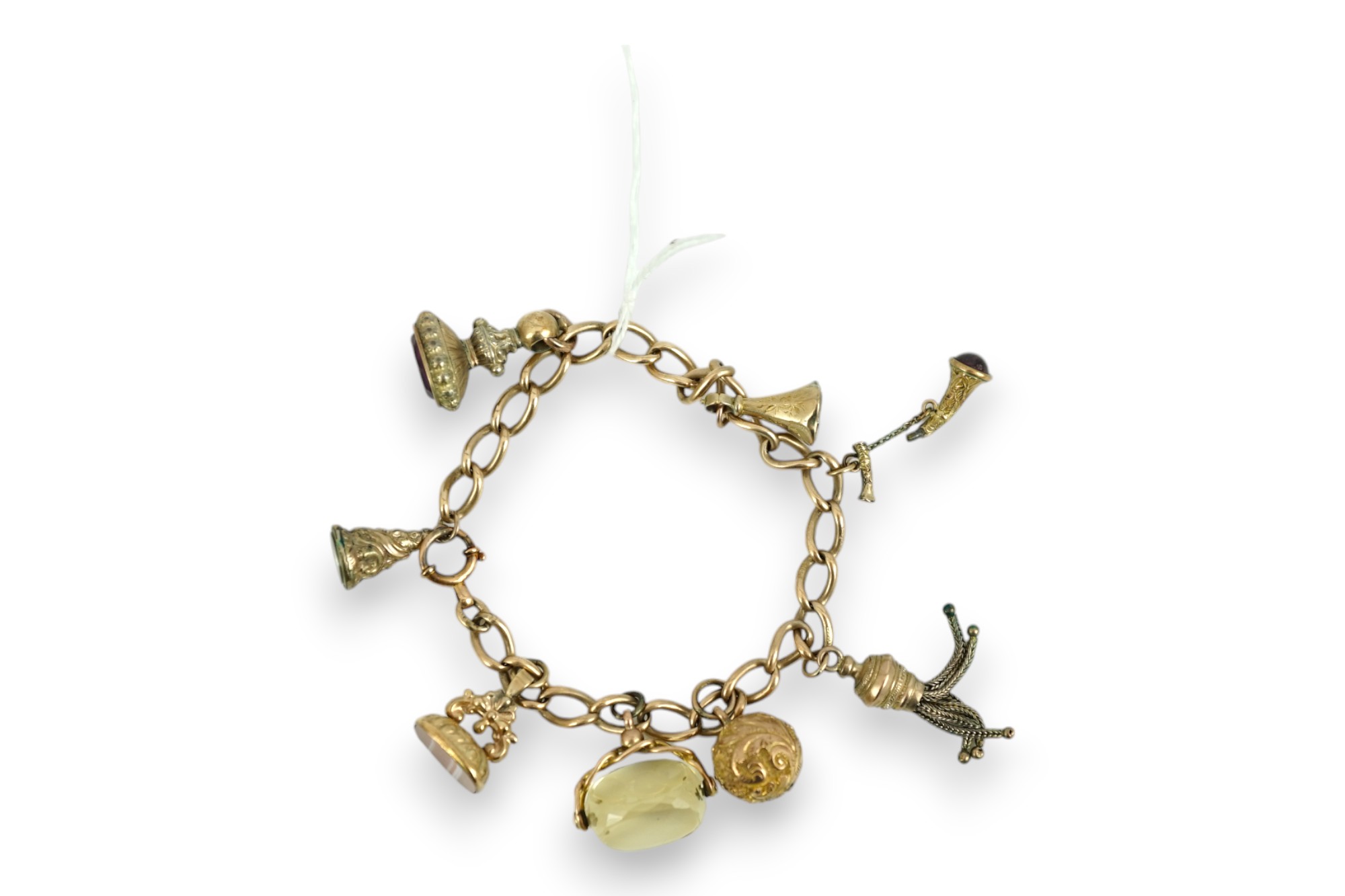 A 9ct gold charm bracelet, hung with eight assorted yellow metal overlaid charms, gross weight 33.4 grams.